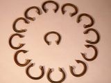 a lot of horseshoes arranged in a circle on a table