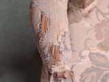 a close up of a chair with a broken arm