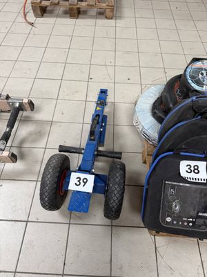 un petit chariot sur lequel sont posés un pneu et un sac à dos