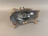 a silver plate with a clock on it on a table