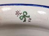a close up of a bowl with a green bow on it