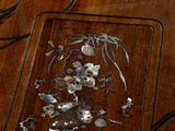 a wooden table with a flower design on it