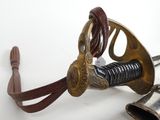 a sword and a bell on a white surface