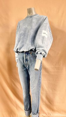 an image of a mannequin wearing a blue sweater and jeans