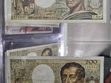 two pieces of paper money with a portrait of a man and a woman on them