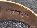 a close up of a gold ring with a name engraved on it