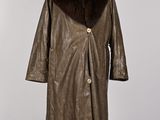 a brown leather coat with a fur collar on a mannequin