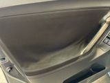 a close up of a car door handle with a phone in it