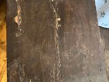a piece of wood sitting on the floor next to a couch