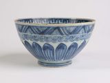 a blue and white bowl sitting on a white surface