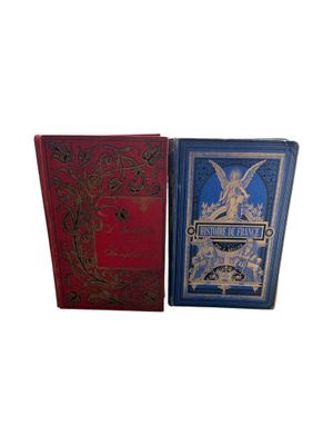 two books sitting next to each other on a white surface