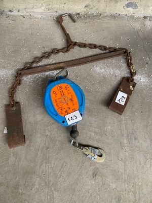 a blue and orange tape measure on a chain