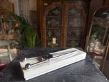two spoons and a spoon rest on a book on a table