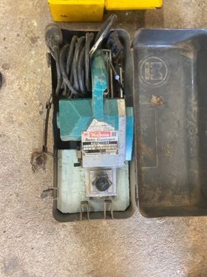 a small box with a tool in it on the floor
