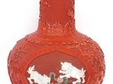 a red vase with a picture of two dogs on it