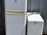 two refrigerators sitting next to each other in front of a building