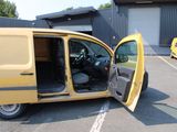 a yellow van with its door open in a parking lot