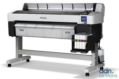 a large format printer on a stand with a roll of ink