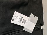 a label on the back of a black backpack