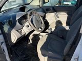 the interior of a car with the door open and the driver ' s seat down