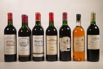 several bottles of wine are lined up in a row on a table