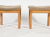 pair of stools with upholstered seats on a white background