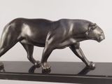 a bronze sculpture of a bear on a black base