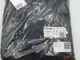 a close up of a bag of black plastic material on a white surface