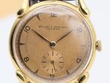 an image of a close up of a wrist watch on a white surface