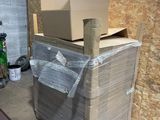 a large box sitting on top of a pallet in a garage