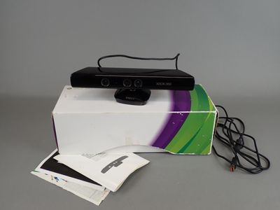 a black webcam sitting on top of a white box