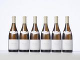 six bottles of wine lined up in a row on a table