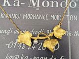 une photo d'un collier en or orné de feuilles