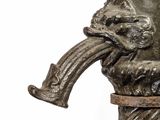 a statue of a man with a pipe sticking out of his mouth