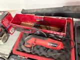 a red box with tools in it sitting on a table