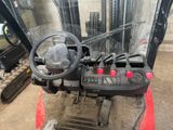 a close up of a forklift with a steering wheel