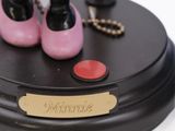 minnie mouse figurine on a black base with pink shoes and a necklace