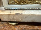 a close up of a gold statue on a wooden table