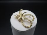 a close up of a ring with a bow on top of it