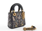 a black and gold handbag with a chain around it