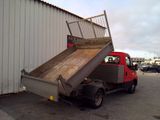 a red truck that has a ramp on the back of it