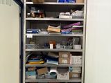 a room with a lot of boxes and papers on the shelves