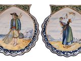 pair of decorative plates with figures on them on a white background