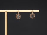 a pair of gold earrings with blue topaz and diamonds