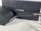 prada sunglasses in a black case and a pair of glasses