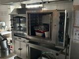a kitchen with a stove, oven, sink, and other appliances