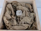 a wooden box with a cloth in it on a white surface