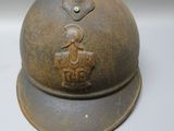 a helmet with a bird on it on a white surface