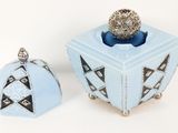 a small blue box with a silver ball on top of it