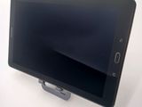 a tablet that is sitting on a stand on a table